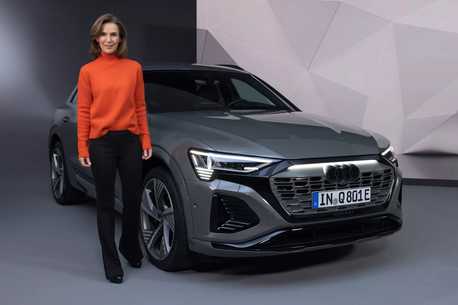 Pohled z předního úhlu na Audi Q8 e-tron 2023 s LED světlomety, šestiúhelníkovou přední mřížkou a elegantními designovými liniemi
