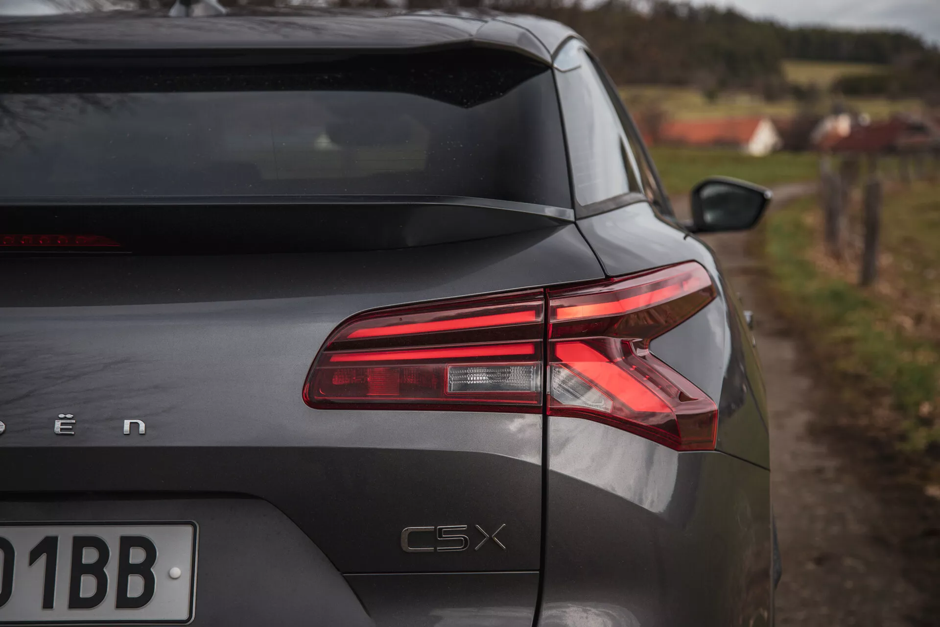 Zadní část Citroen C5-X 2022 pod šikmým úhlem ukazující LED zadní světla, lesklý povrch a označení modelu