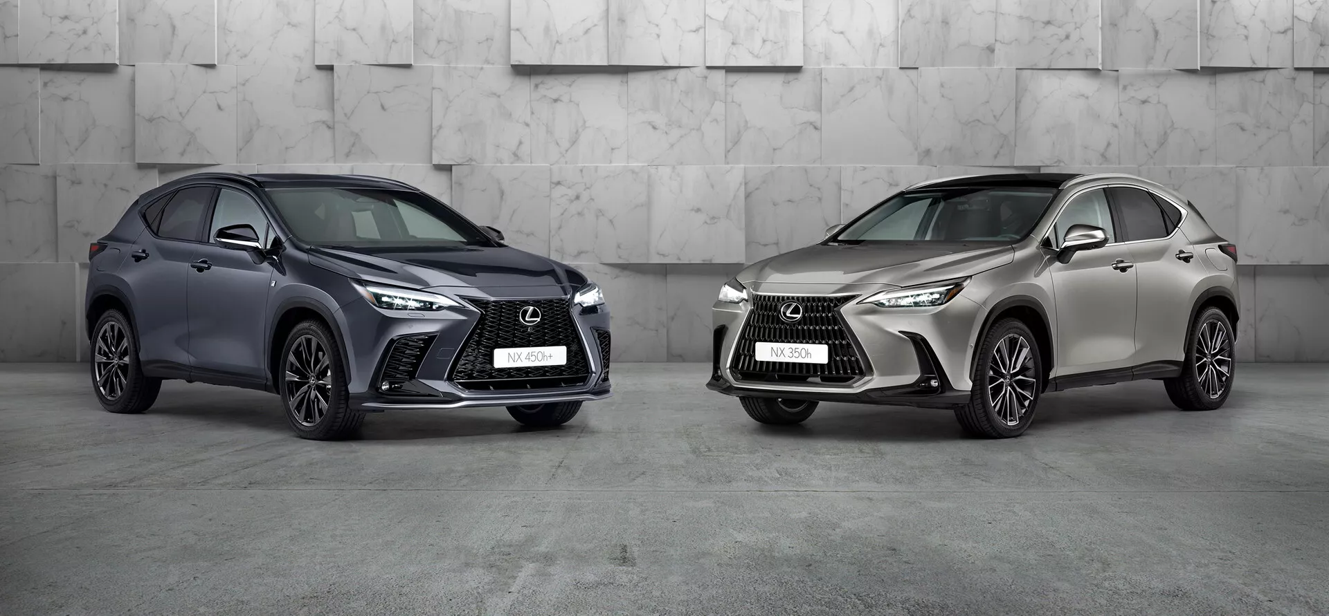 Obrázek zobrazuje dva vozy Lexus NX 2021 v profesionálním studiovém prostředí. Vůz vlevo, tmavě zbarvené kompaktní SUV s výraznou agresivní přední mřížkou, ostrými LED světlomety a velkými přívody vzduchu, je natočen tak, aby zobrazoval svůj levý předek a boční stranu. Kola jsou otočena směrem ke kameře, což zdůrazňuje design ráfků. Vůz vpravo, ve světle kovové barvě, také natočený, ale doleva, sdílí podobný designový jazyk s odlišným styl rámových ráfků. Obě luxusní SUV, výrazně umístěná ve snímku, vykazují pokročilý design a možné moderní technologie.