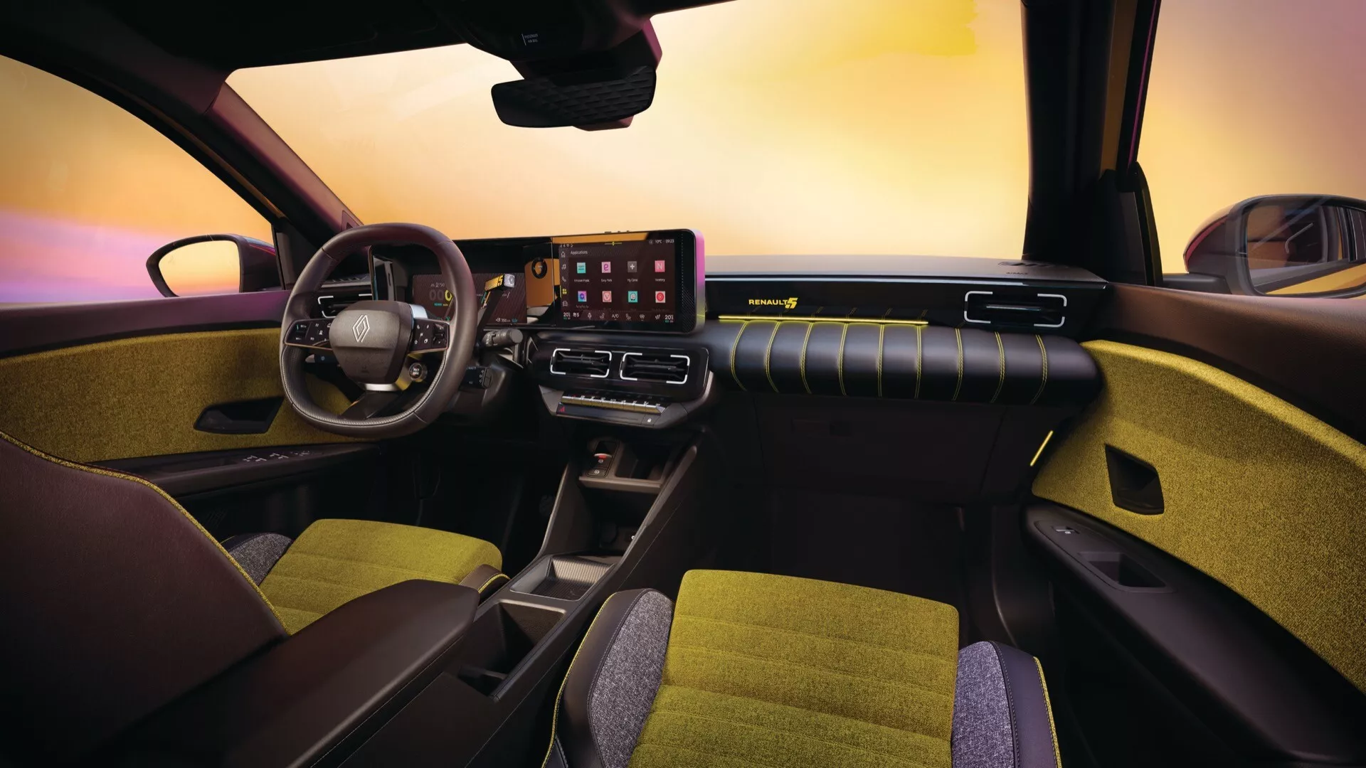 Interiér Renault R5 2024 z pohledu předního spolujezdce, zdůrazňující multifunkční volant, digitální přístrojovou desku, velkou dotykovou obrazovku infotainmentu a elegantní design vzduchového výdechu na palubní desce s ambientním osvětlením.