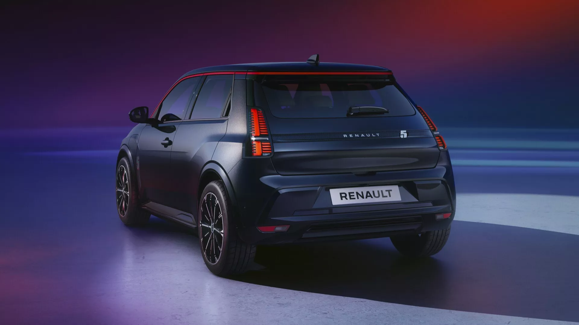 Zadní trojčtvrteční pohled na Renault R5 2024 zdůrazňující LED zadní světla, sportovní slitinová kola a prémiový matný povrch na pozadí s přechodem
