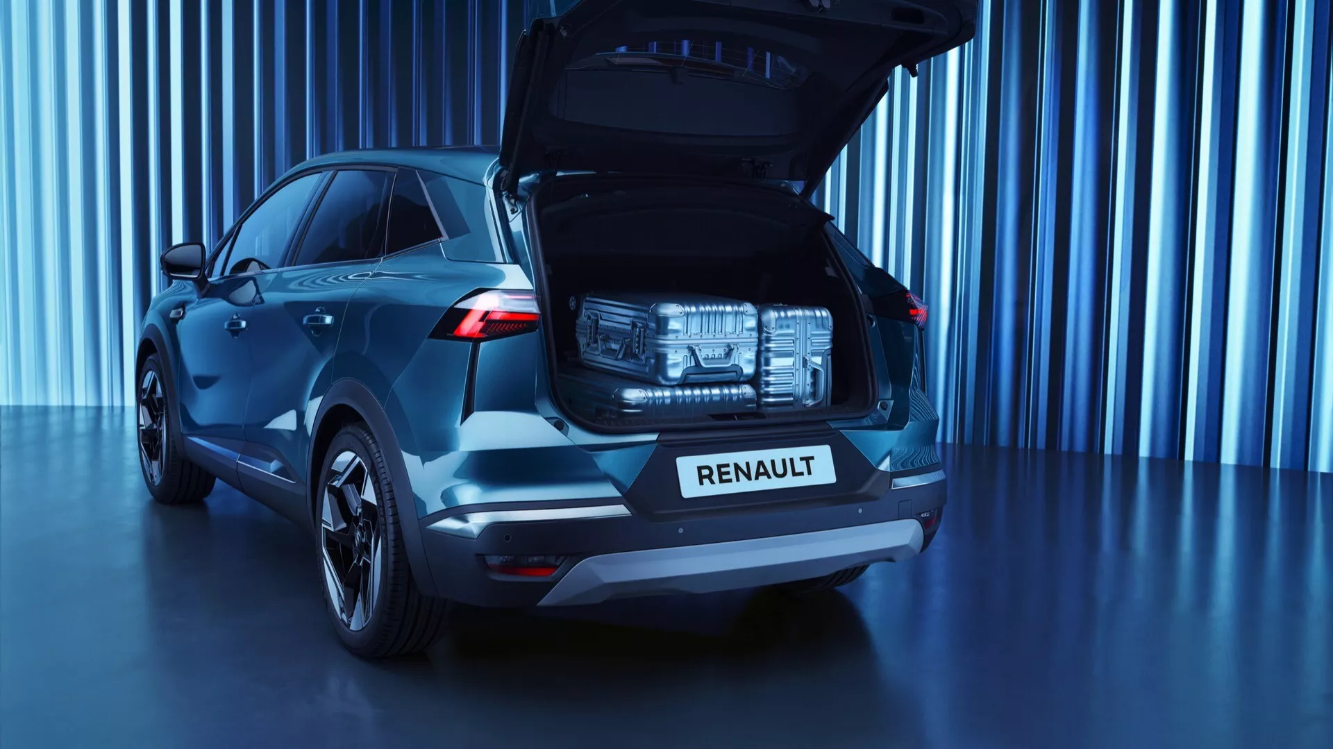 Zadní tříčtvrteční pohled na první generaci Renault Symbioz 2024 SUV v tmavě modré barvě, se zobrazeným prostorným otevřeným kufrem, výraznými LED zadními světly, chromovanou nápisem 'RENAULT' na víku kufru, moderním designem zadního skla, vícepaprskovými slitými koly a studiovým prostředím s futuristickým modrým tónovaným pozadím.