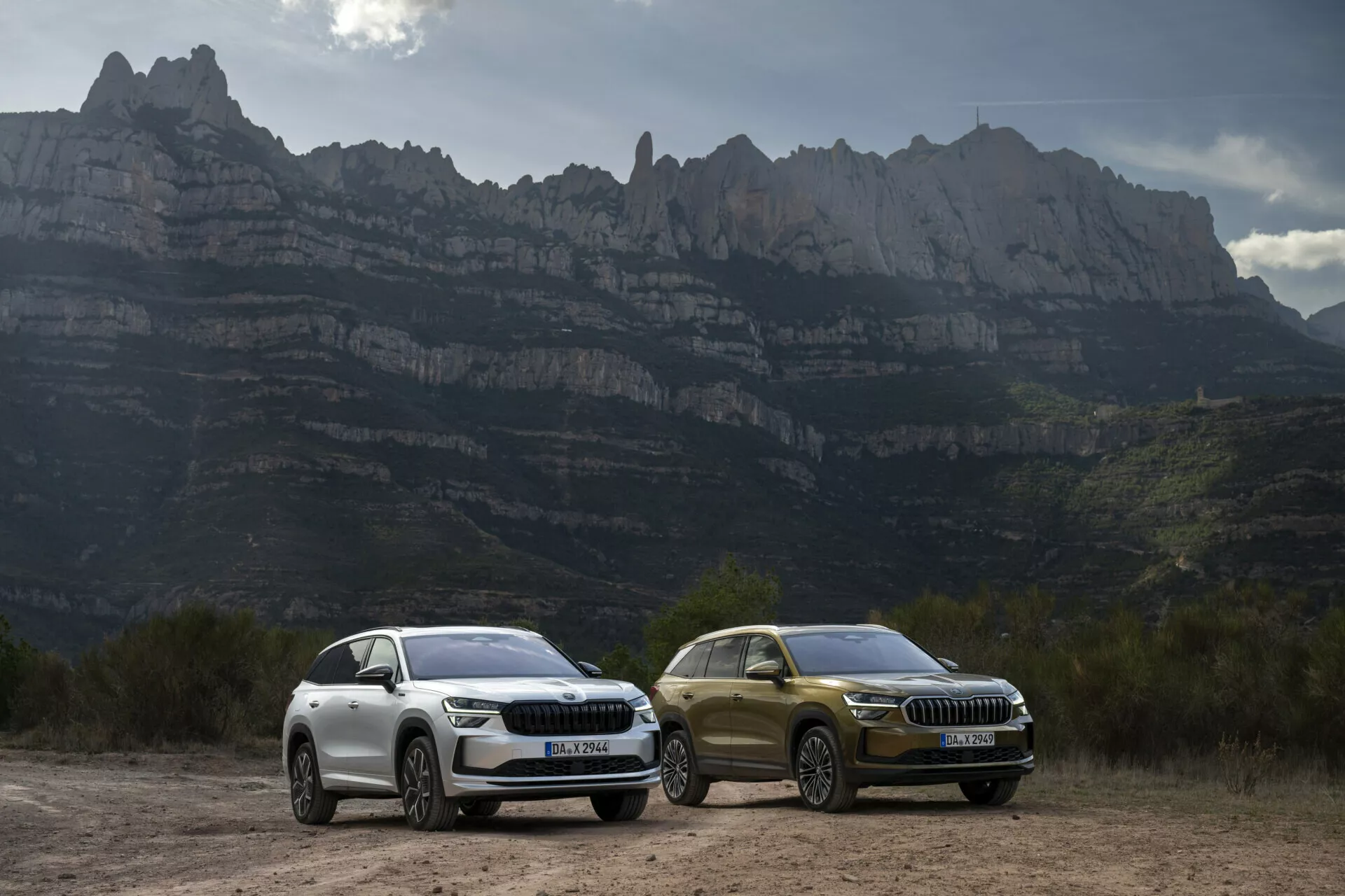 SUV Skoda Kodiaq 2024 s LED světly a luxusními designovými prvky zaparkovaná venku na pozadí horské krajiny, zdůrazňující aerodynamické vlastnosti, slitinová kola a pokročilou technologii vhodnou pro dobrodružnou jízdu.