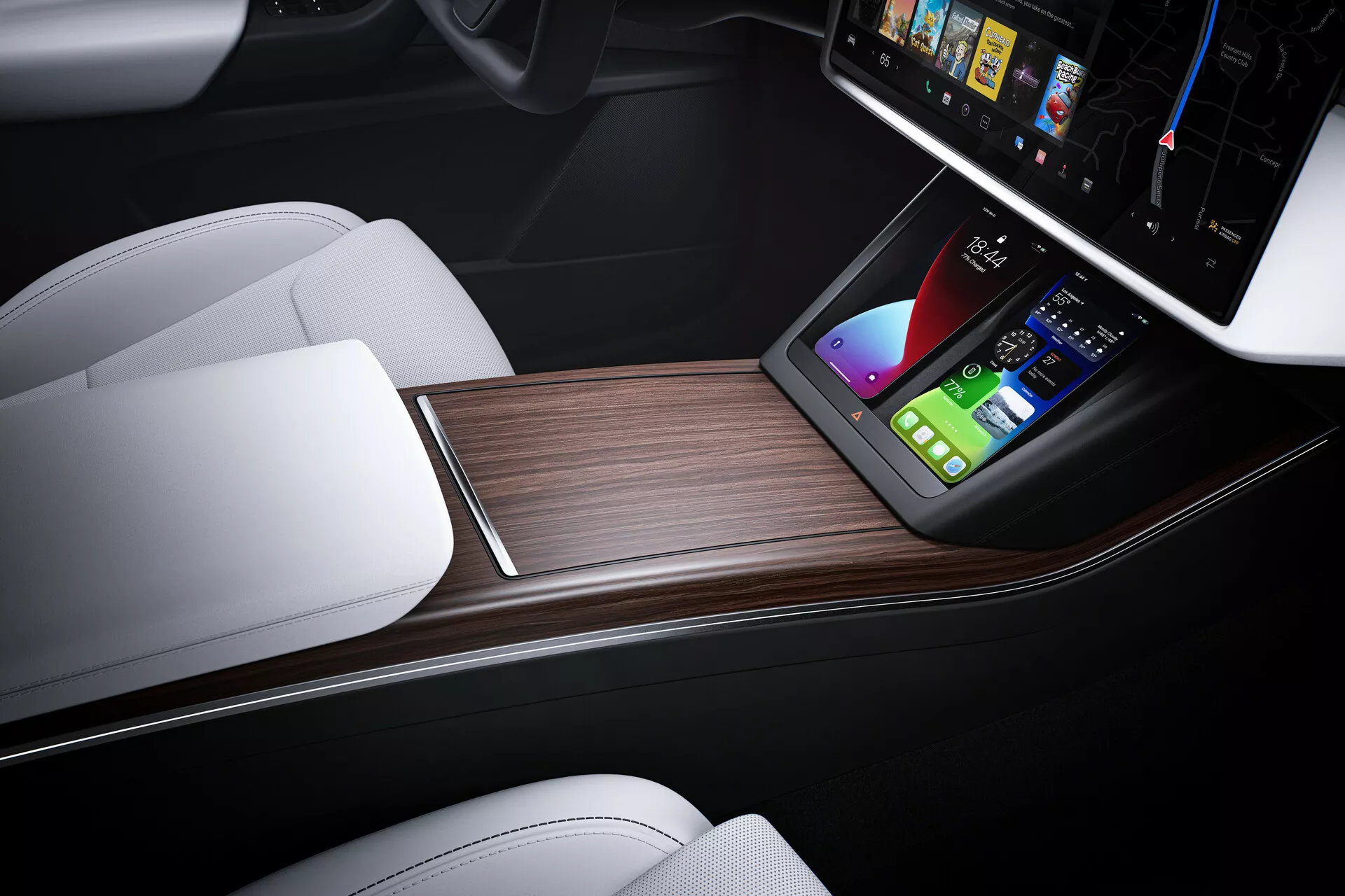 Zblízka záběr interiéru Tesla Model X 2021 (1. generace facelift) středové konzole. Snímek z výšky s mírným sklonem vpřed ukazuje elegantní design s velkou vertikální dotykovou obrazovkou zobrazující pokročilé infotainmentové možnosti, jako je navigace a ovládání médií. Pod dotykovou obrazovkou je bezdrátová nabíjecí podložka pro smartphony, umístěná v luxusní konzoli s kontrastními bílými koženými sedačkami a tmavým obložením, doplněná dřevěným dekorem. Tento obrázek reprezentuje moderní automobilové inženýrství, špičkové automobilové funkce a luxusní designové prvky.