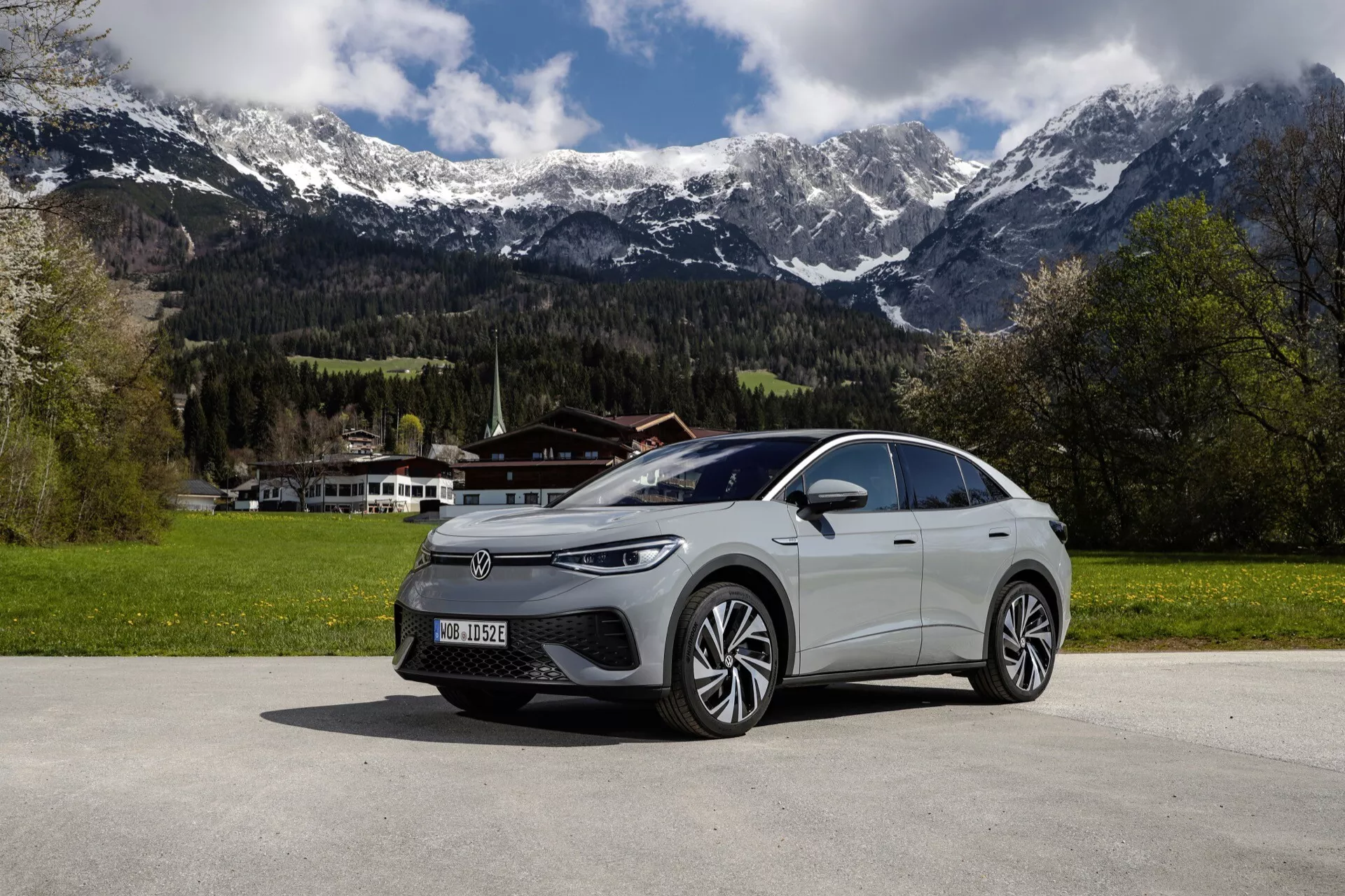 Boční pohled na Volkswagen ID.5 první generace z roku 2022, ukazující jeho elegantní aerodynamický design, pokročilý osvětlovací systém a moderní křivky v sofistikovaném městském prostředí.